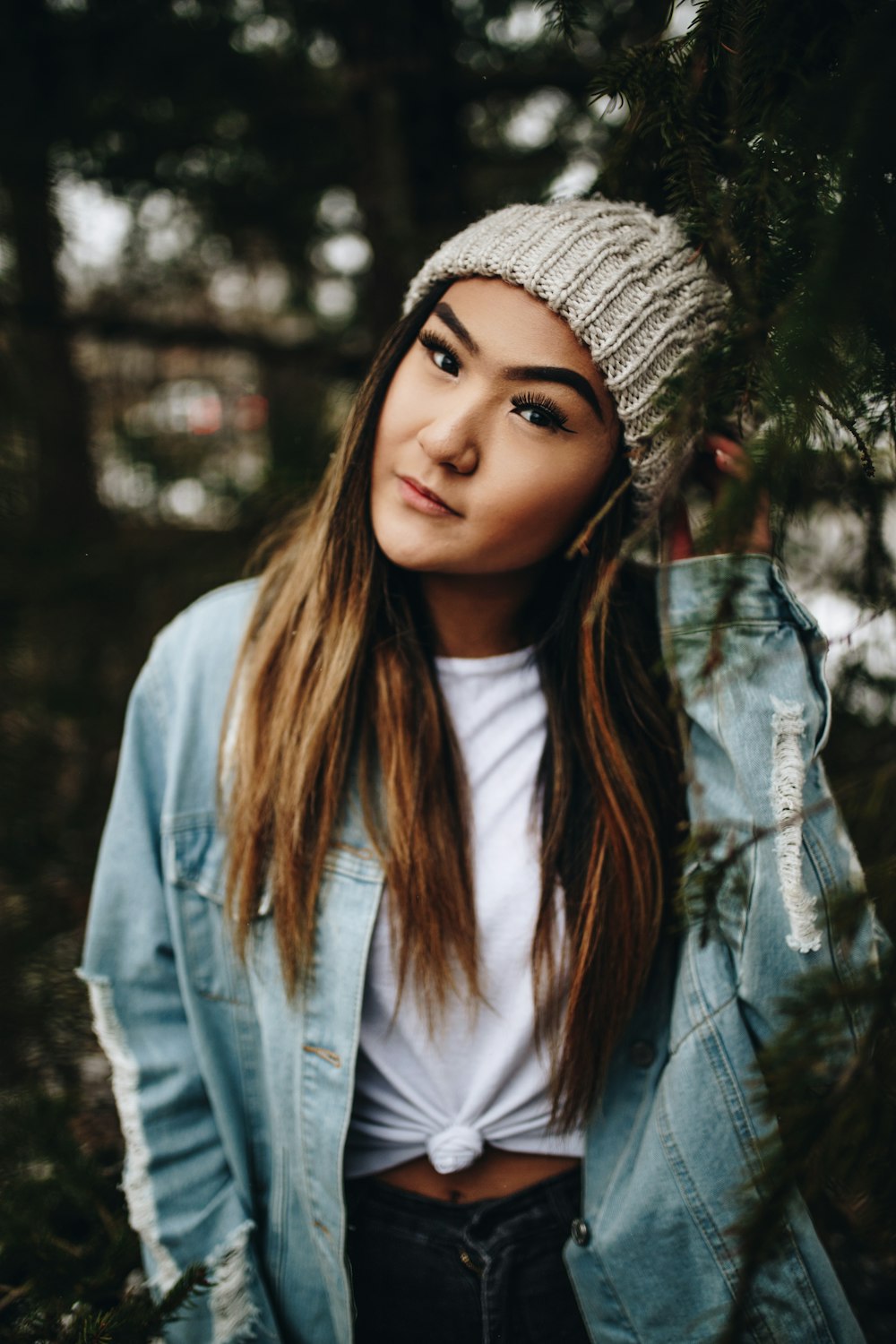 selective focus photography of woman wearing beanie and blue denim jacket