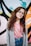 girl wearing eyeglasses with silver frames behind graffiti