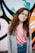 girl wearing eyeglasses with silver frames behind graffiti