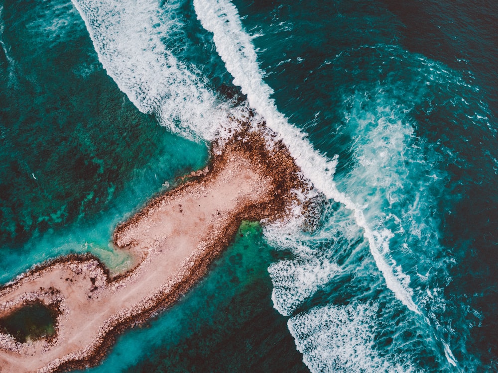 brown island surrounded by sea water during daytime