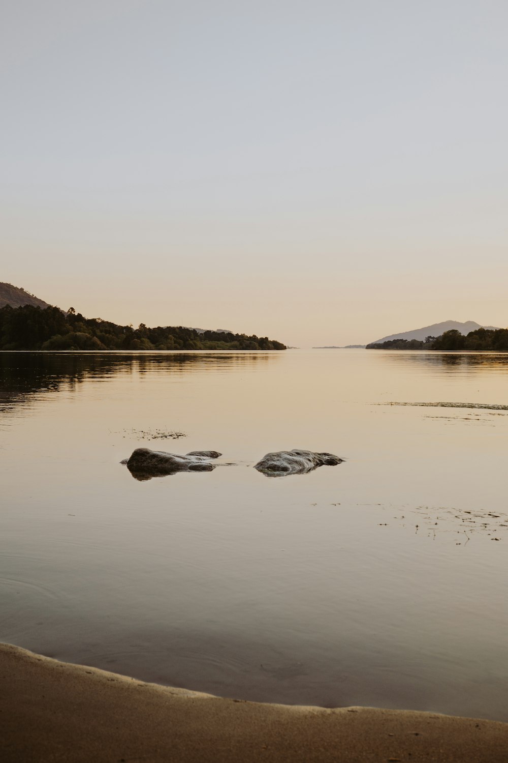 bodies of water near stone at daytime