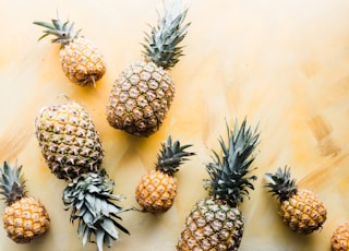 pineapples on brown surface