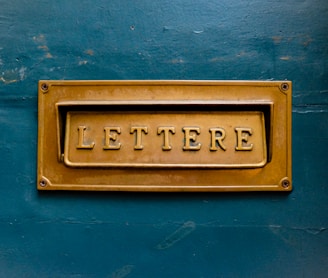 brown Lettere signage on teal trwall