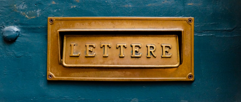 brown Lettere signage on teal trwall