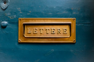 brown Lettere signage on teal trwall