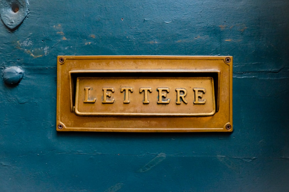 brown Lettere signage on teal trwall