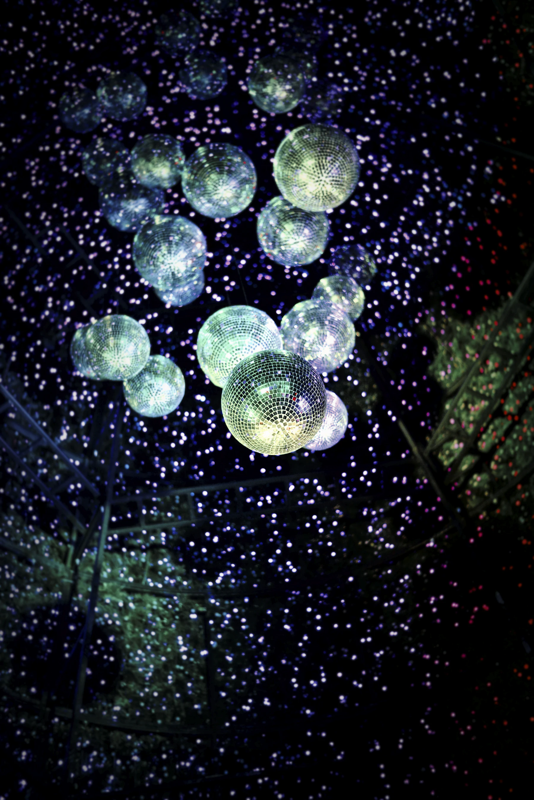 Mirror balls hanging above a party