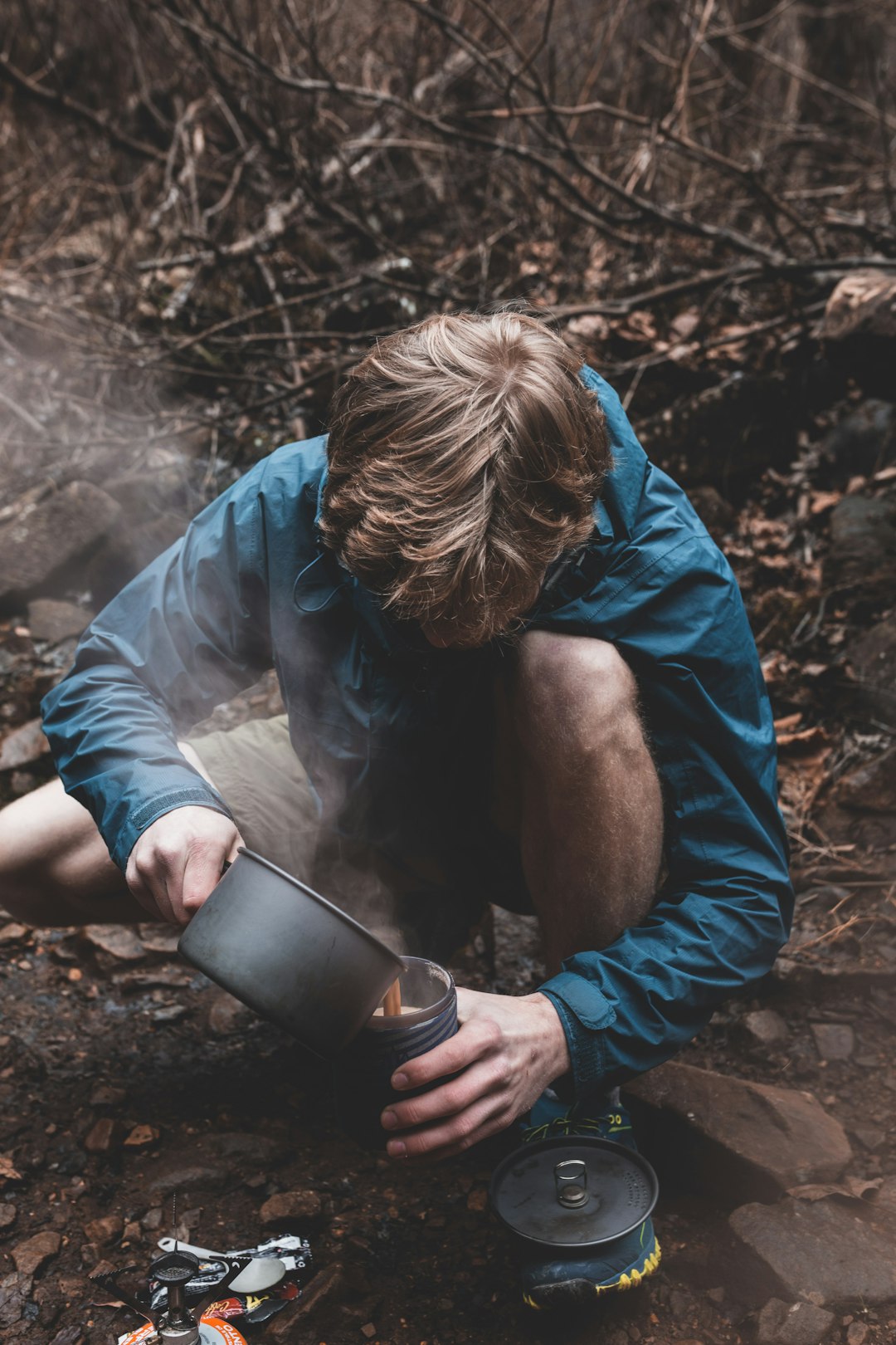 man pouring coffee on cup