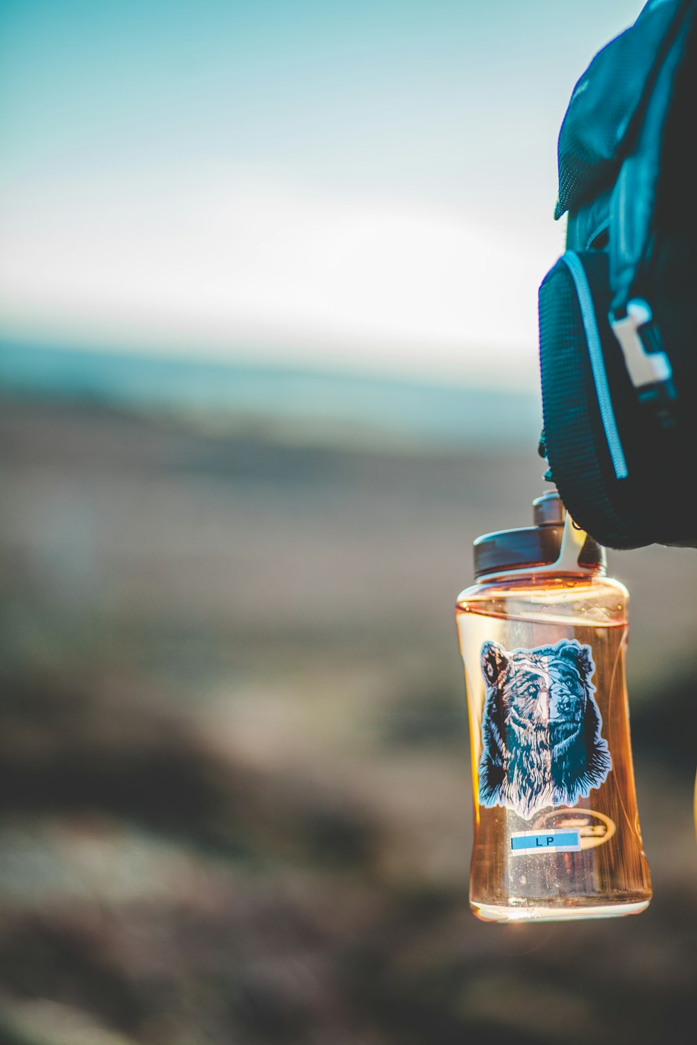 selective focus photo of brown plastic bottle