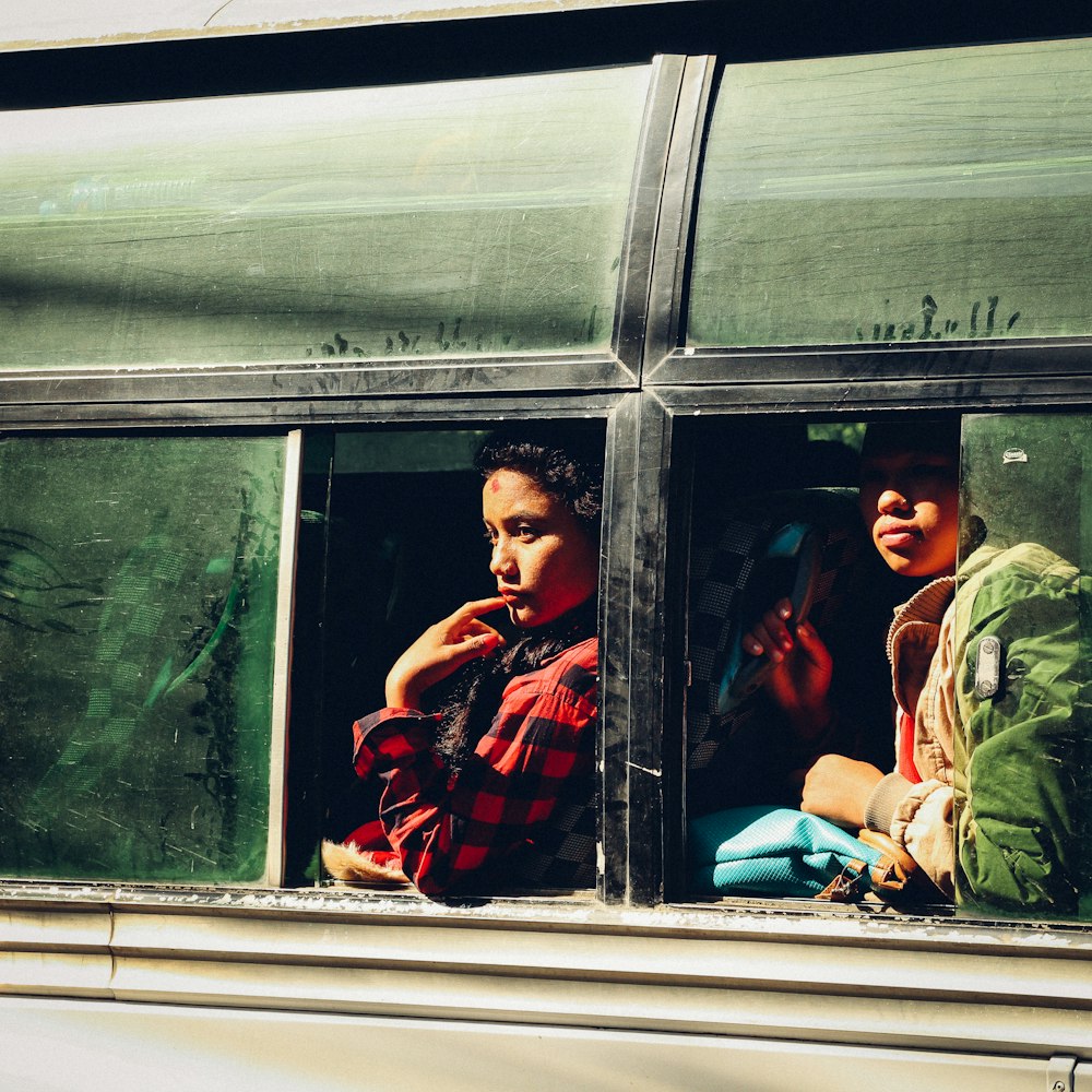 two people sitting on bus