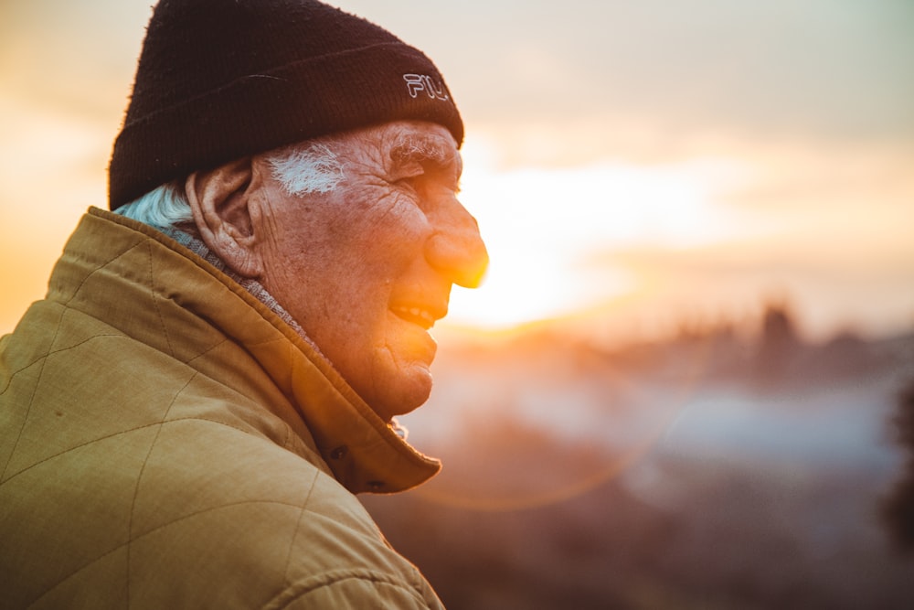 man wearing brown jacket and knit cap