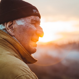 man wearing brown jacket and knit cap