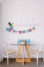 brown and white pub set and happy birthday hanging decor inside room