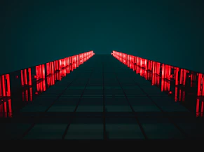 black pathway between red LED light rails