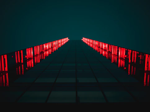 black pathway between red LED light rails
