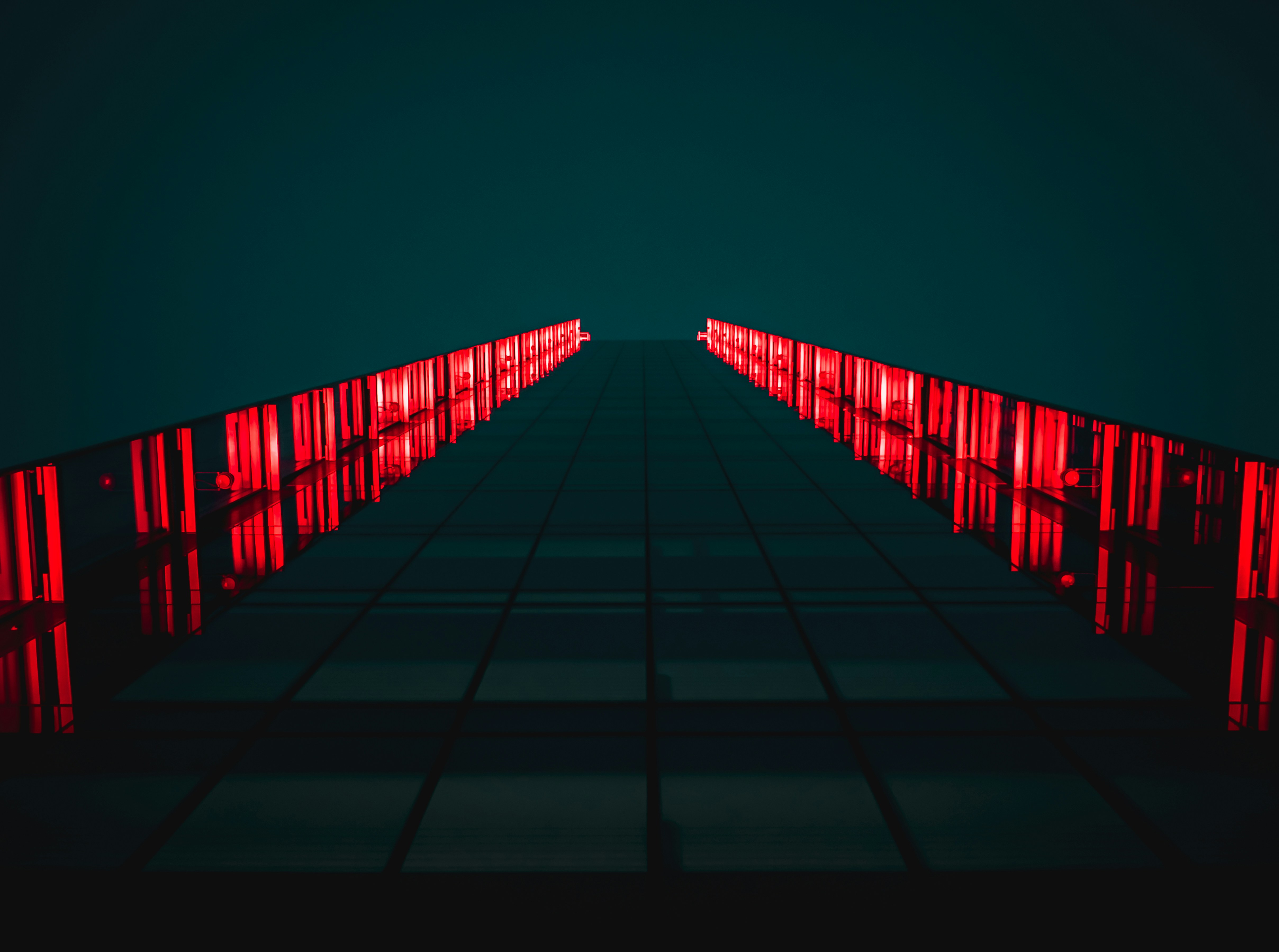 black pathway between red LED light rails
