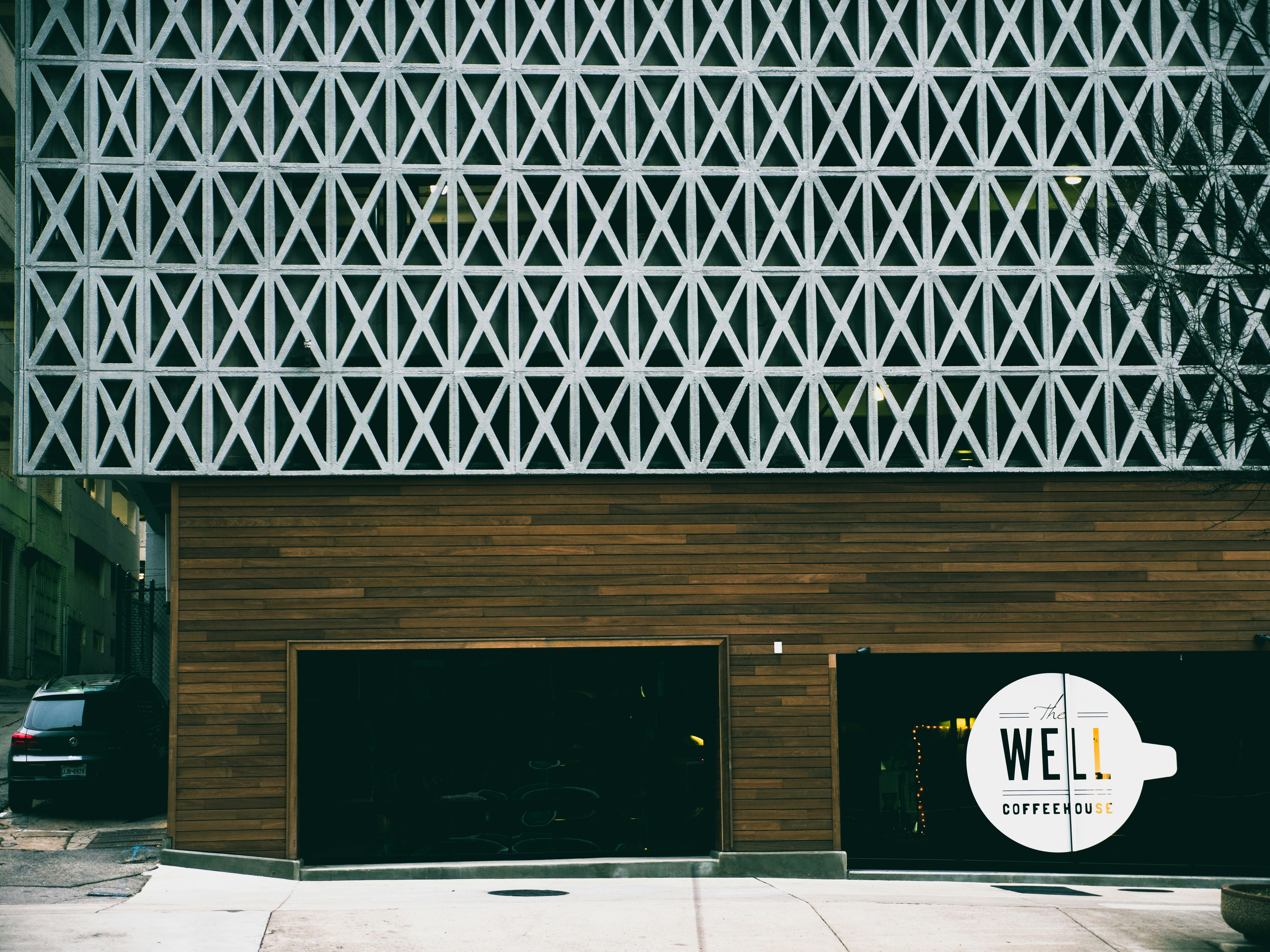 black vehicle parked beside Well storefront, 