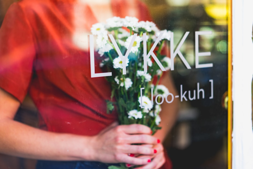 woman holding flowers at daytime