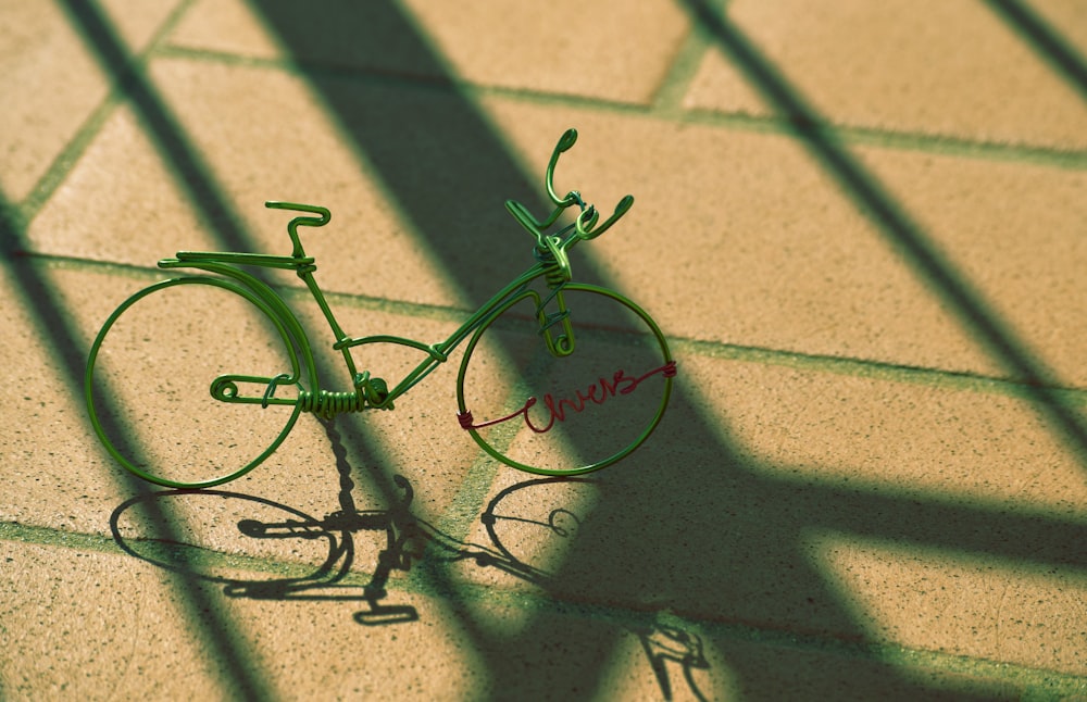 gray bicycle miniature on concrete pavement