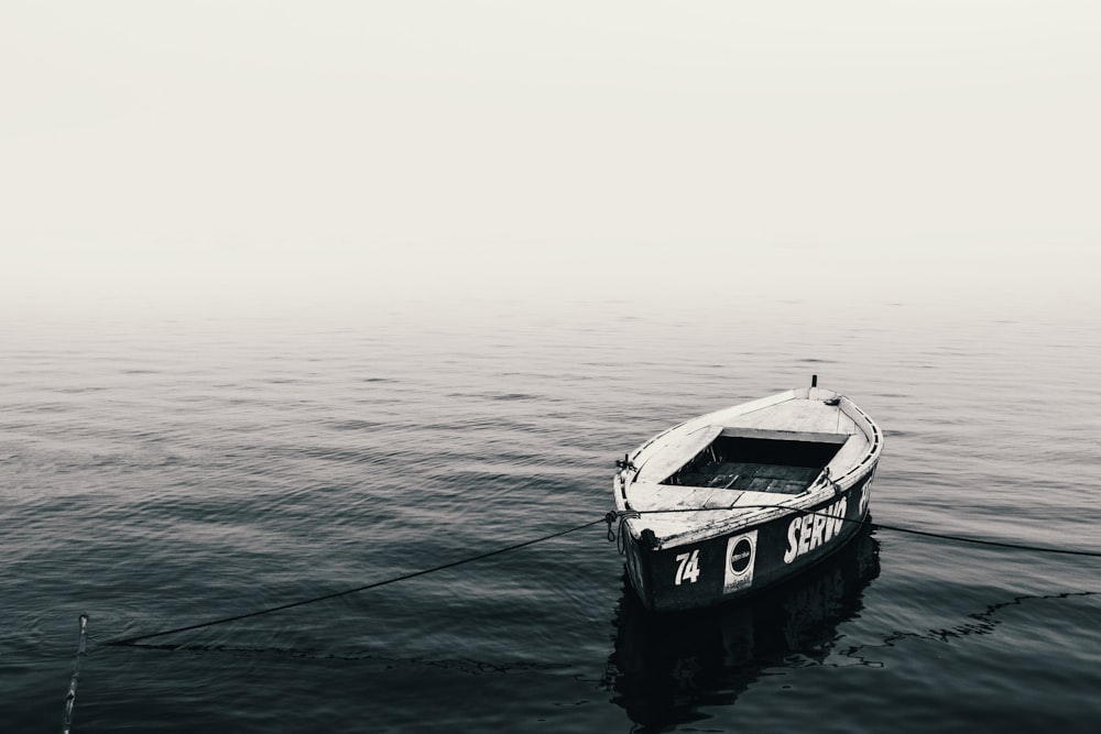 photo of white canoe on body of water