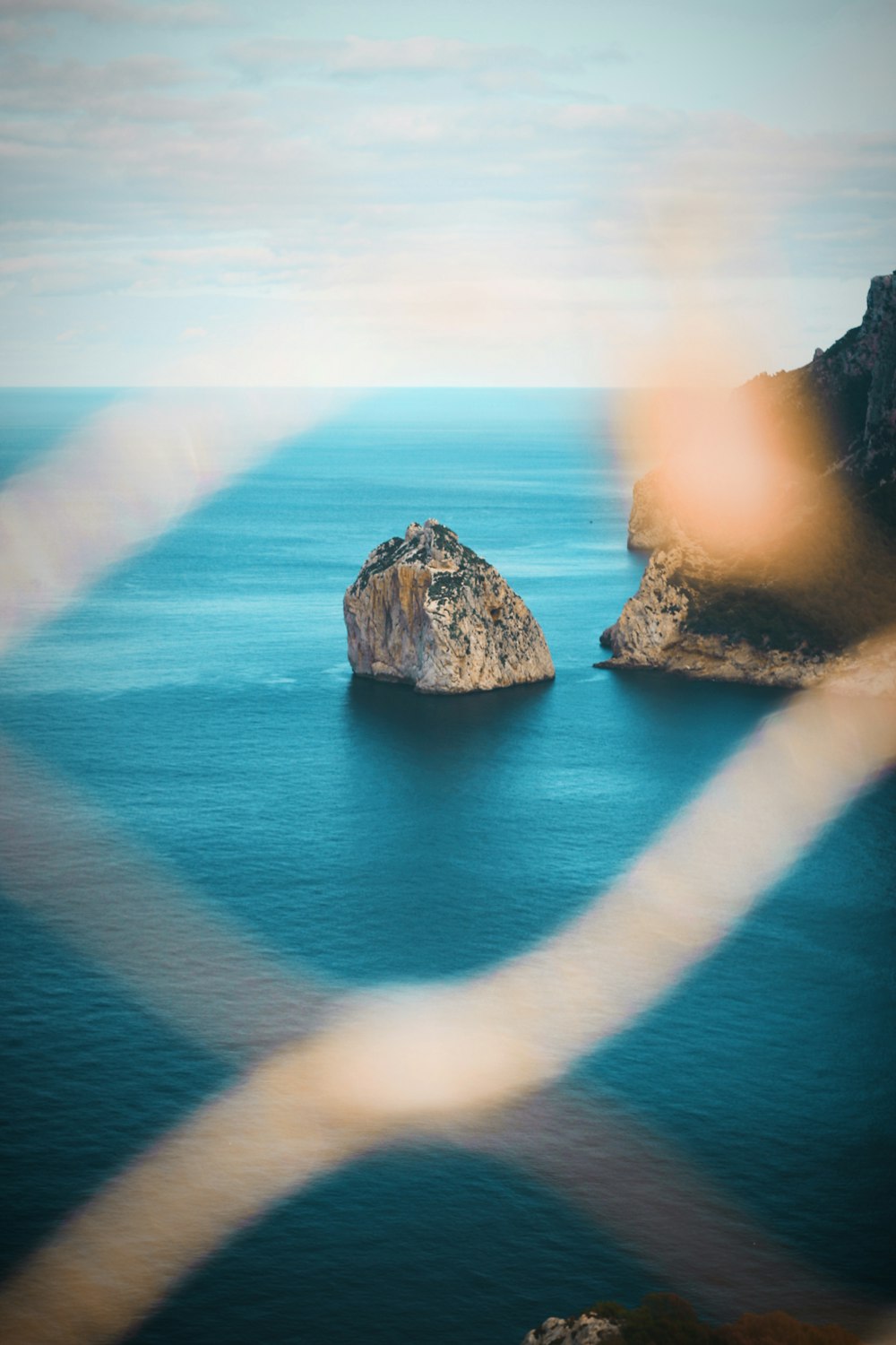 rocky coast under cloudy blue sky