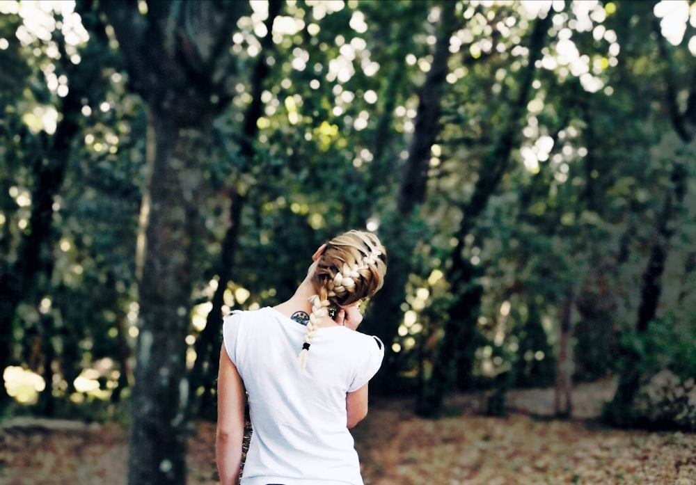 woman standing in forest at daytime