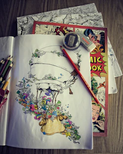 An artist sketching whimsical characters for a children's story, surrounded by colorful pencils and paints.