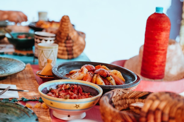 A cozy dining table set with colorful ceramic plates and bamboo utensils.