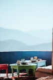 An outdoor setting showcasing a mosaic backsplash against a mountain backdrop.