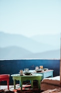 An outdoor setting showcasing a mosaic backsplash against a mountain backdrop.