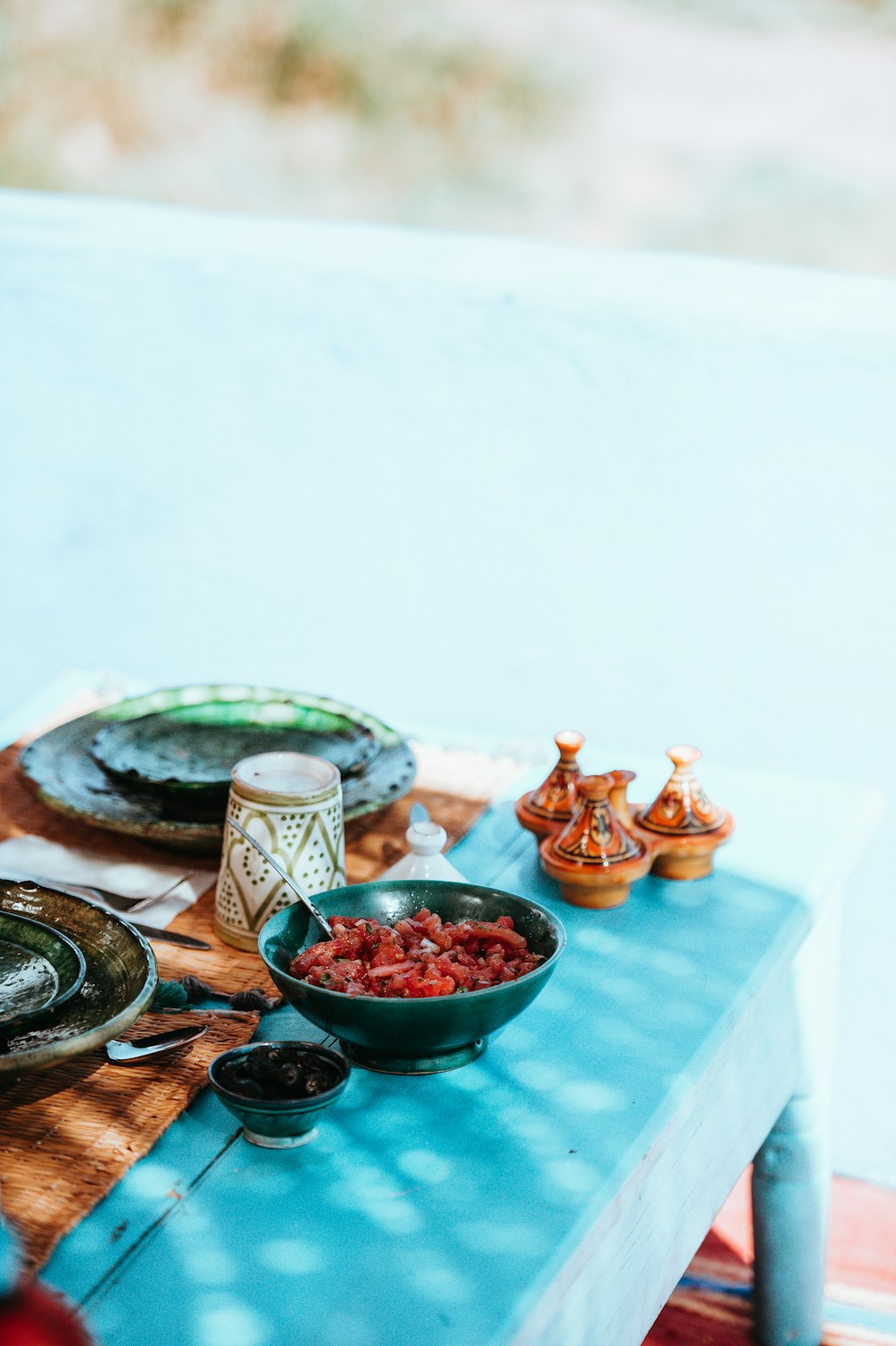 cooked meat on bowl and dishware on top table