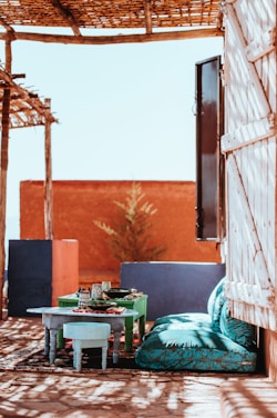 table beside green floral sofa