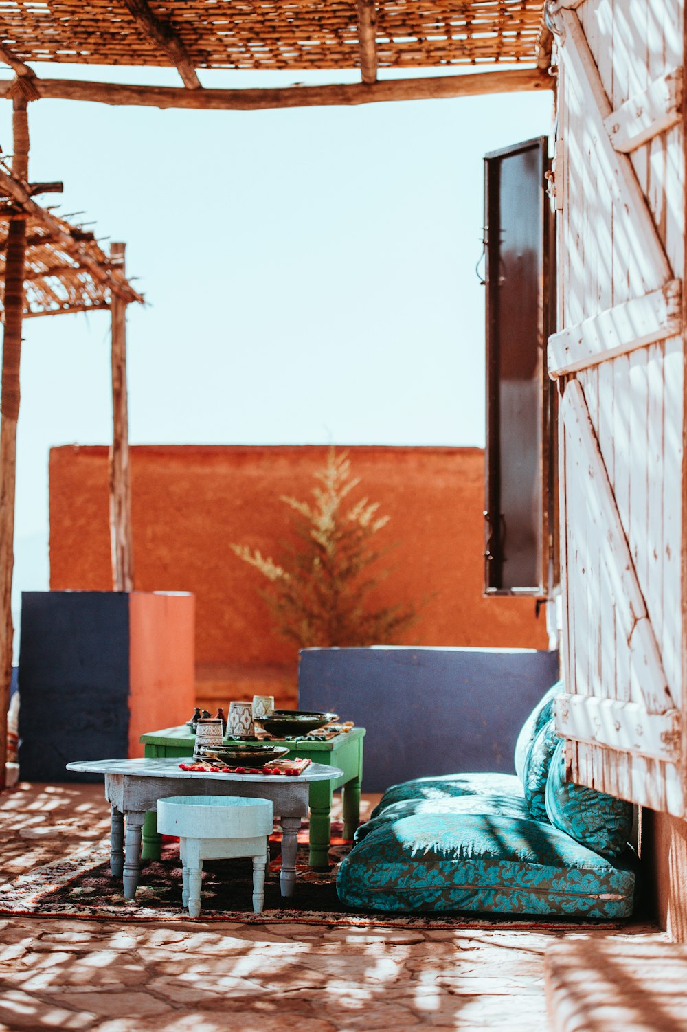 table beside green floral sofa