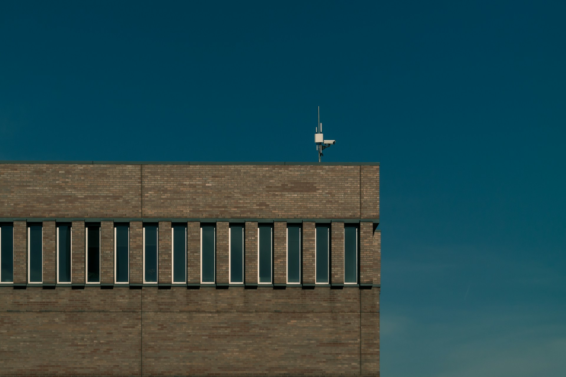 photo of white stand on brown building