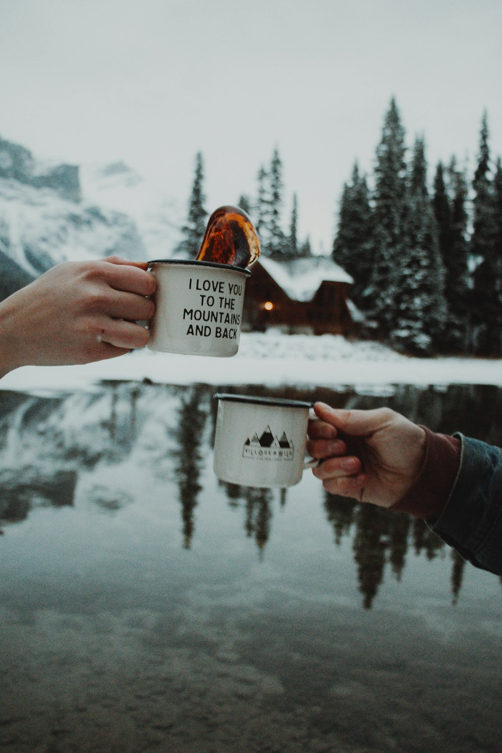 two person toasting their cups outdoors