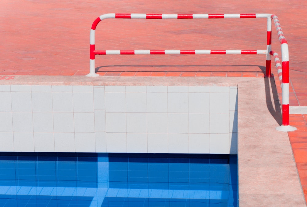 red and white stripe pool rail