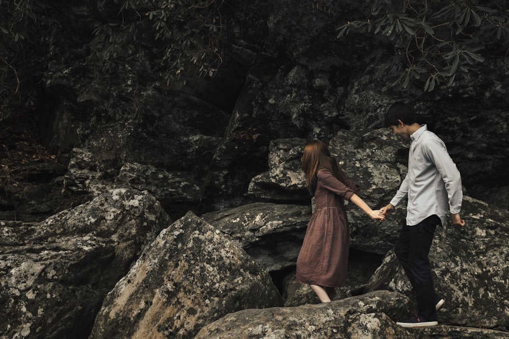 couple standing on rocky cliff