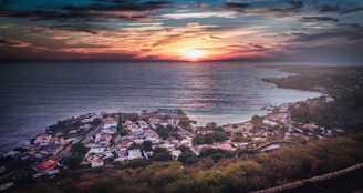 Sunset view of Grottammare's charming coastline with colorful buildings along the shore.