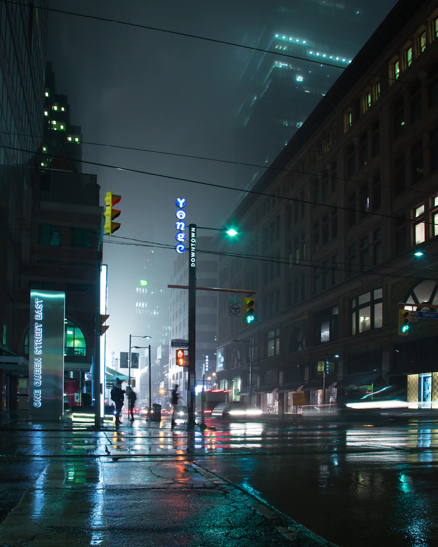 A city block in fog, lit green by a traffic signal