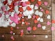 heart-shaped assorted-color cutout decors place on wooden surface