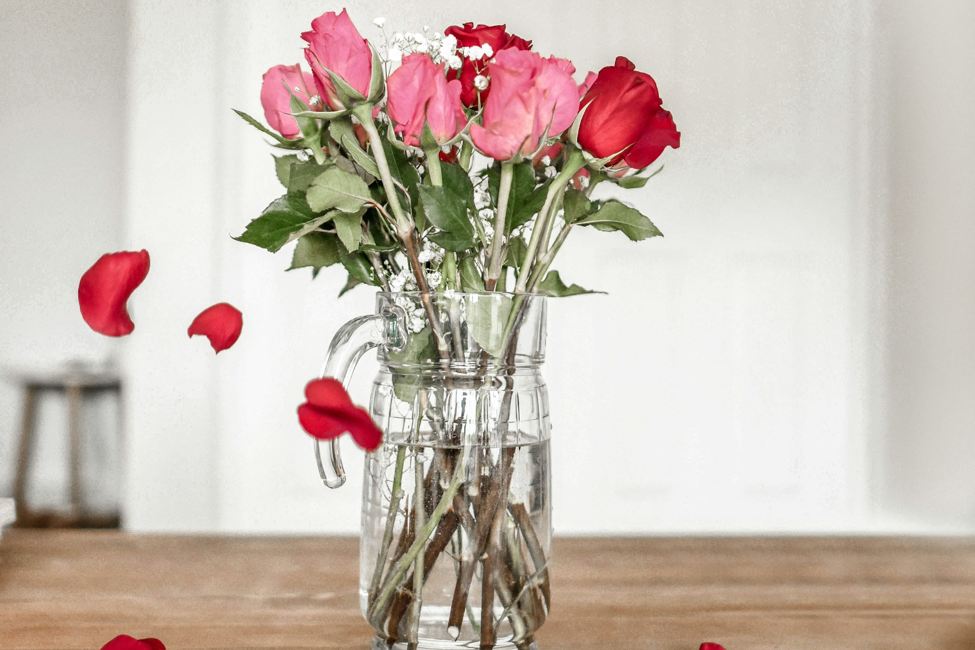pink and red roses on clear glass vase