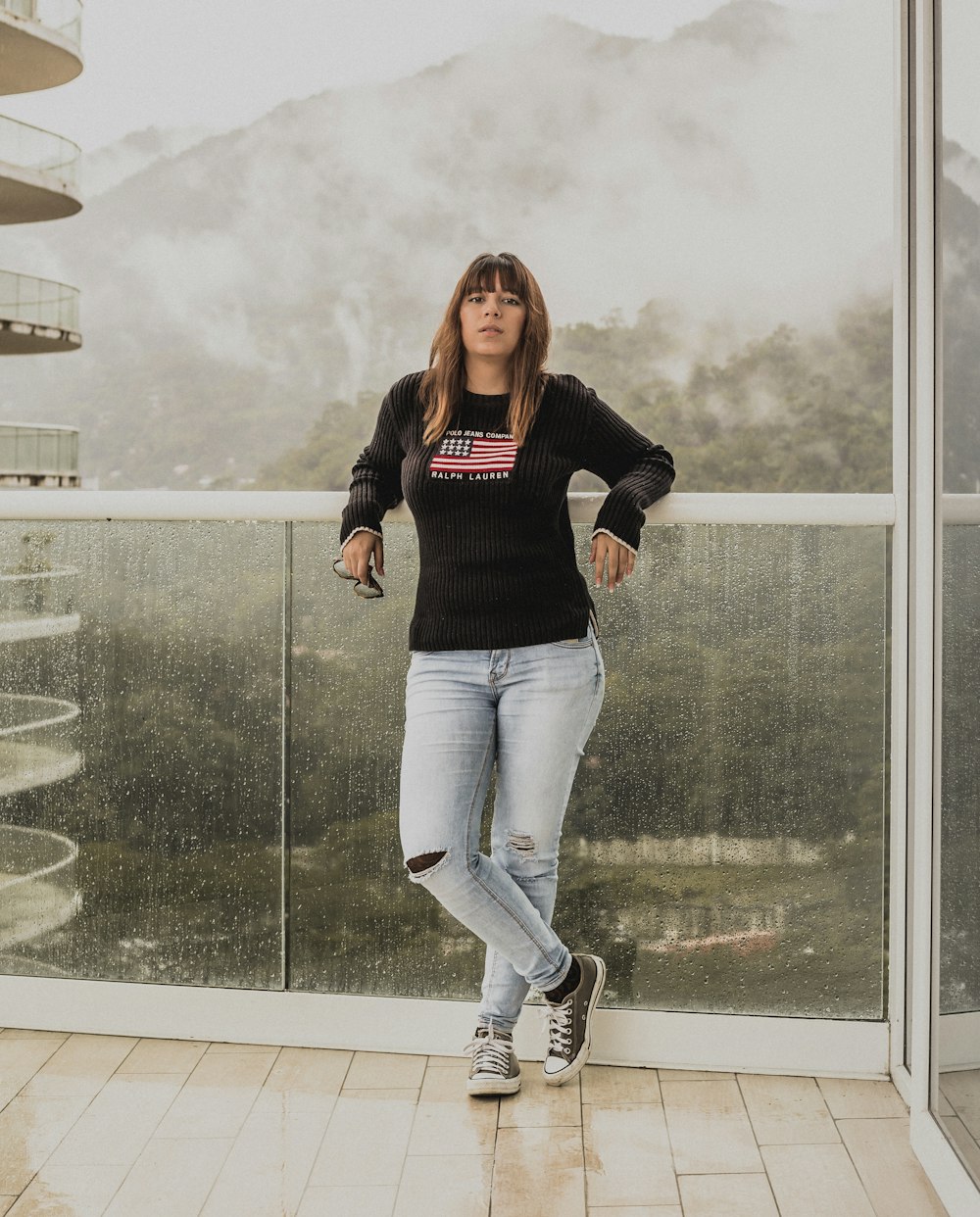 woman leaning on glass wall