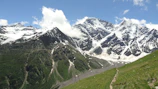 A serene view of the snow-capped peaks surrounding a group trekking in Manali, with clear blue skies above.