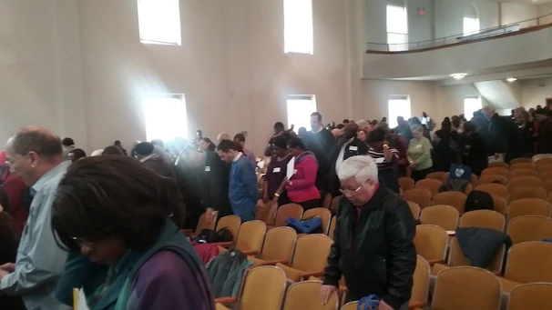 A panoramic view of a packed auditorium filled with eager participants.