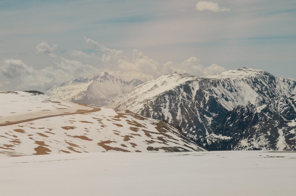 mountain alps under cumulus clouds