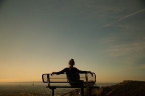 woman sitting on bench during daytime