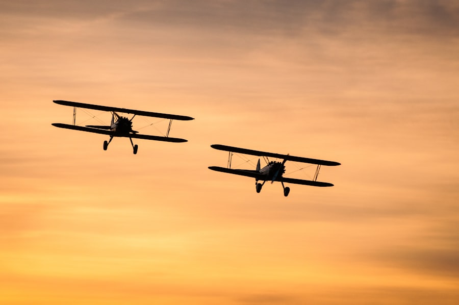 Two vintage biplanes flying in formation against the sky