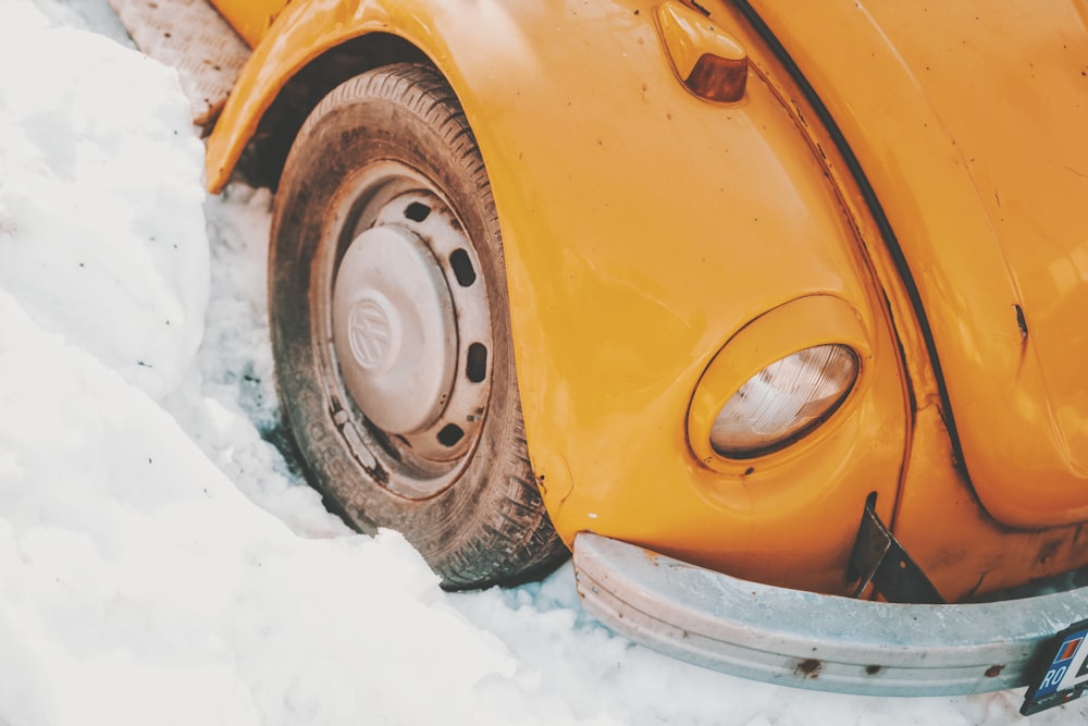 yellow Volkwagen car stack on snow