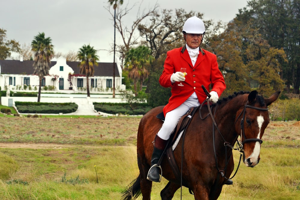 man riding horse on farm during daytime