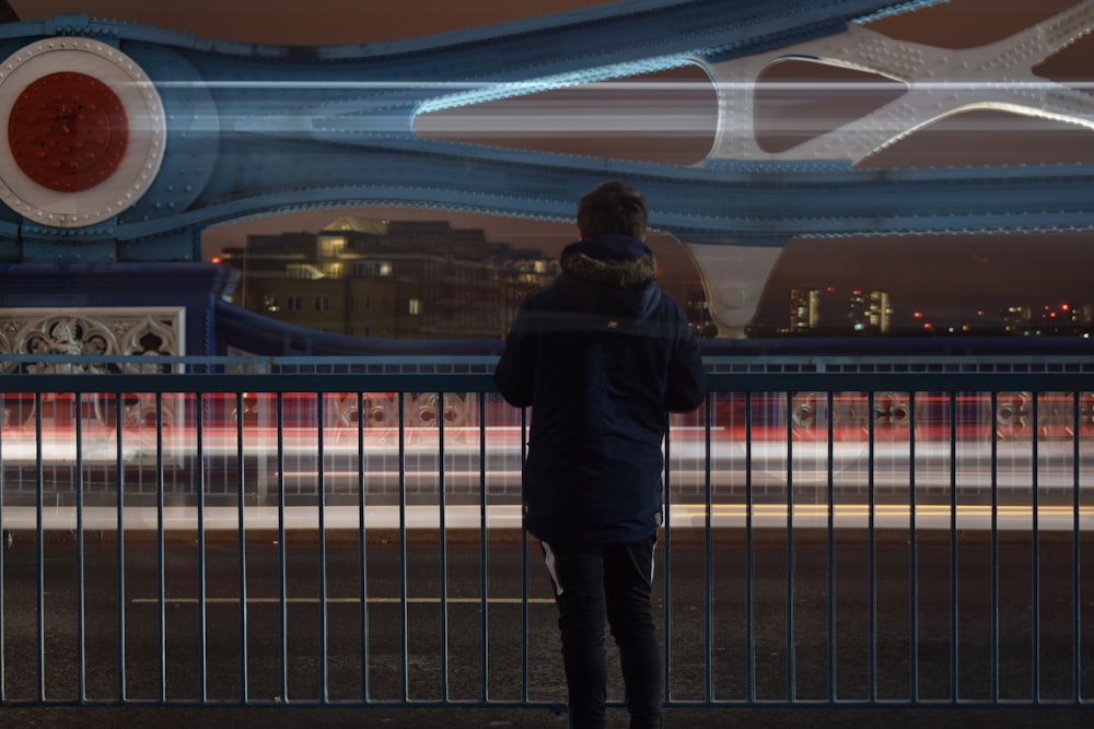 man standing in front of steel railings